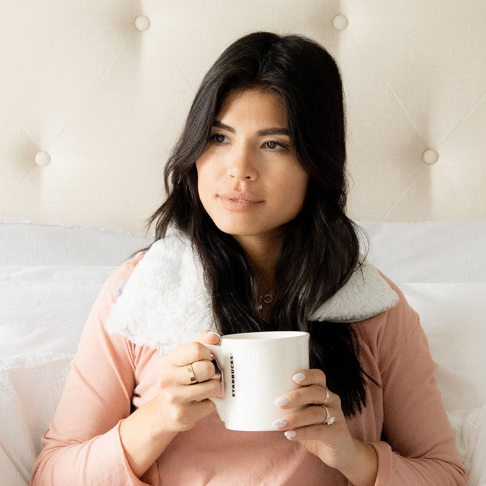 Image 90: Woman relaxing in Soothing Warmies Neck Wrap in Marshmallow Gray
